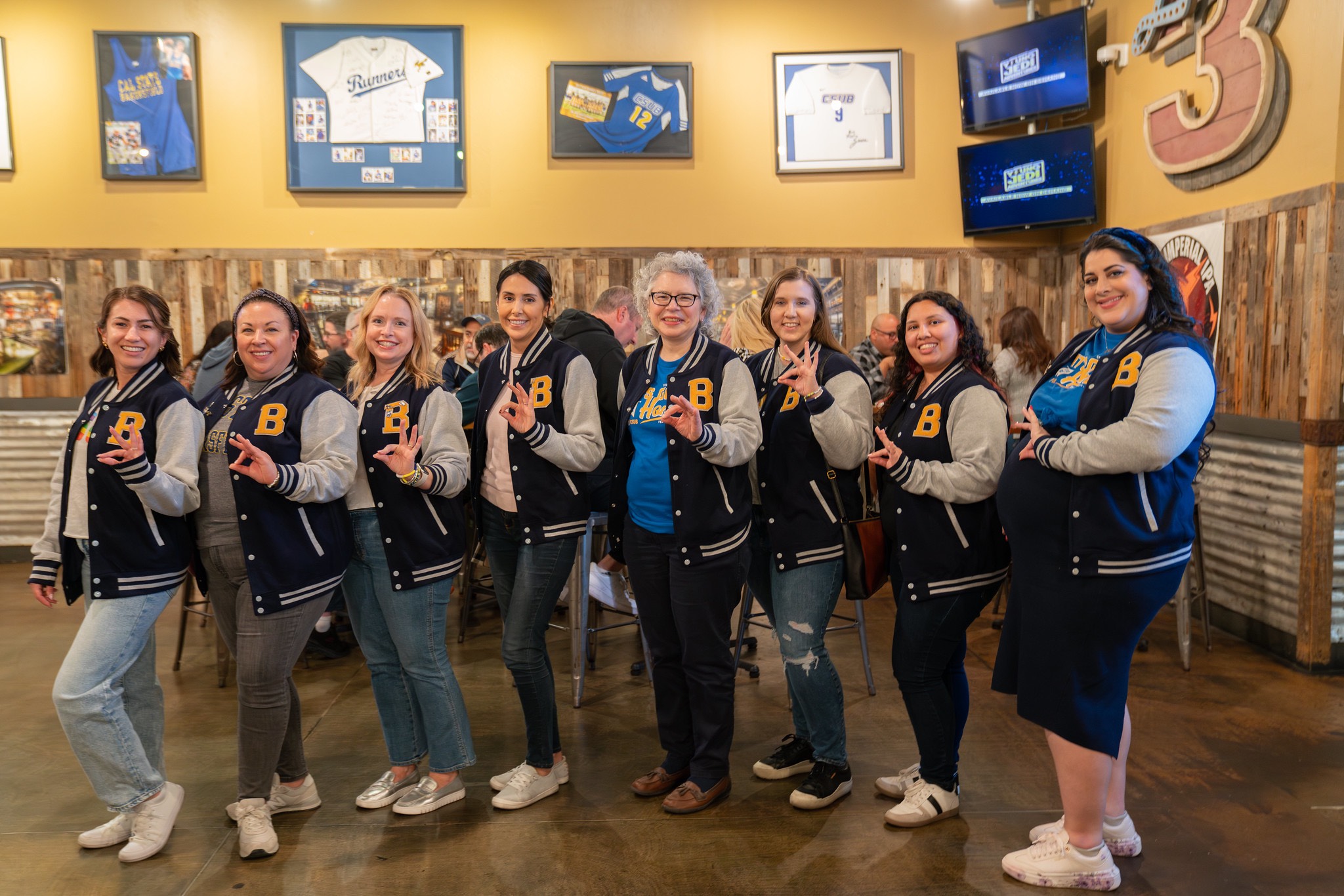 Alumni Family Weekend 2025, alumni pose with their CSUB letterman jackets