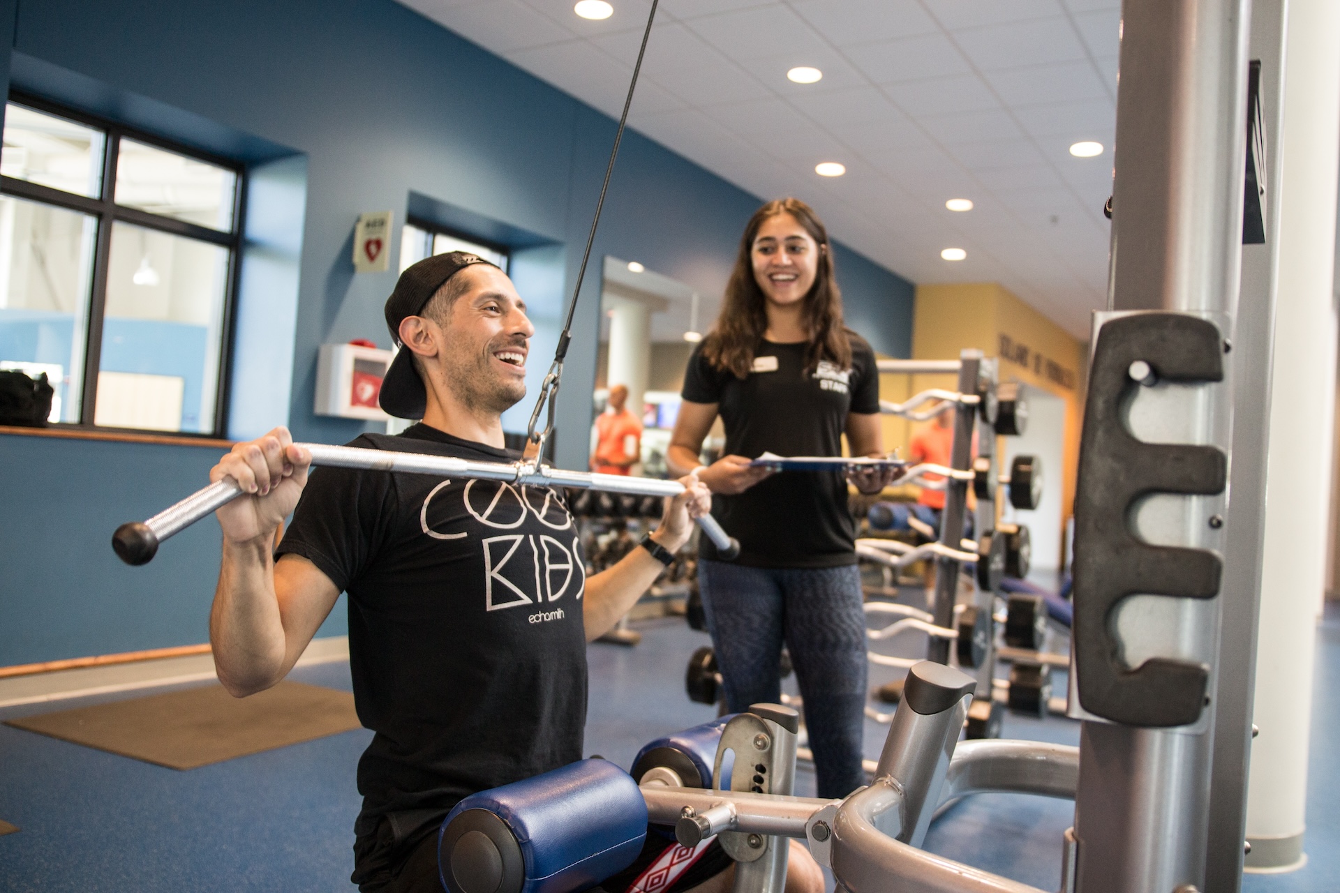 People exercising on a weight machine