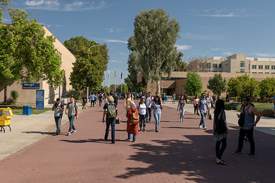 Students walking on the CSUB red brick road