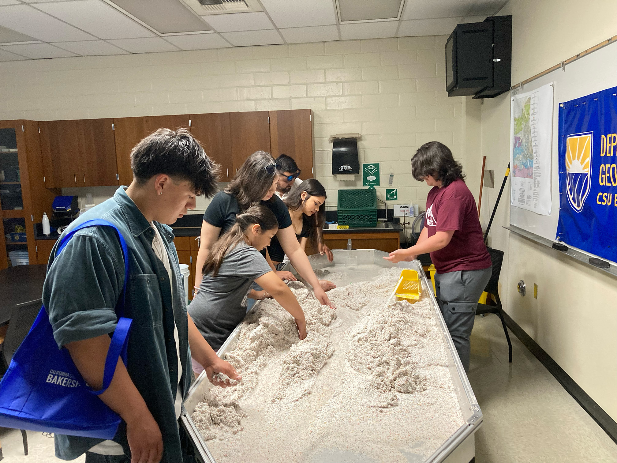 Geology major Andrew shows off the stream table