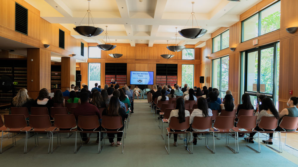 Group of people sitting in chairs and watching a presentation