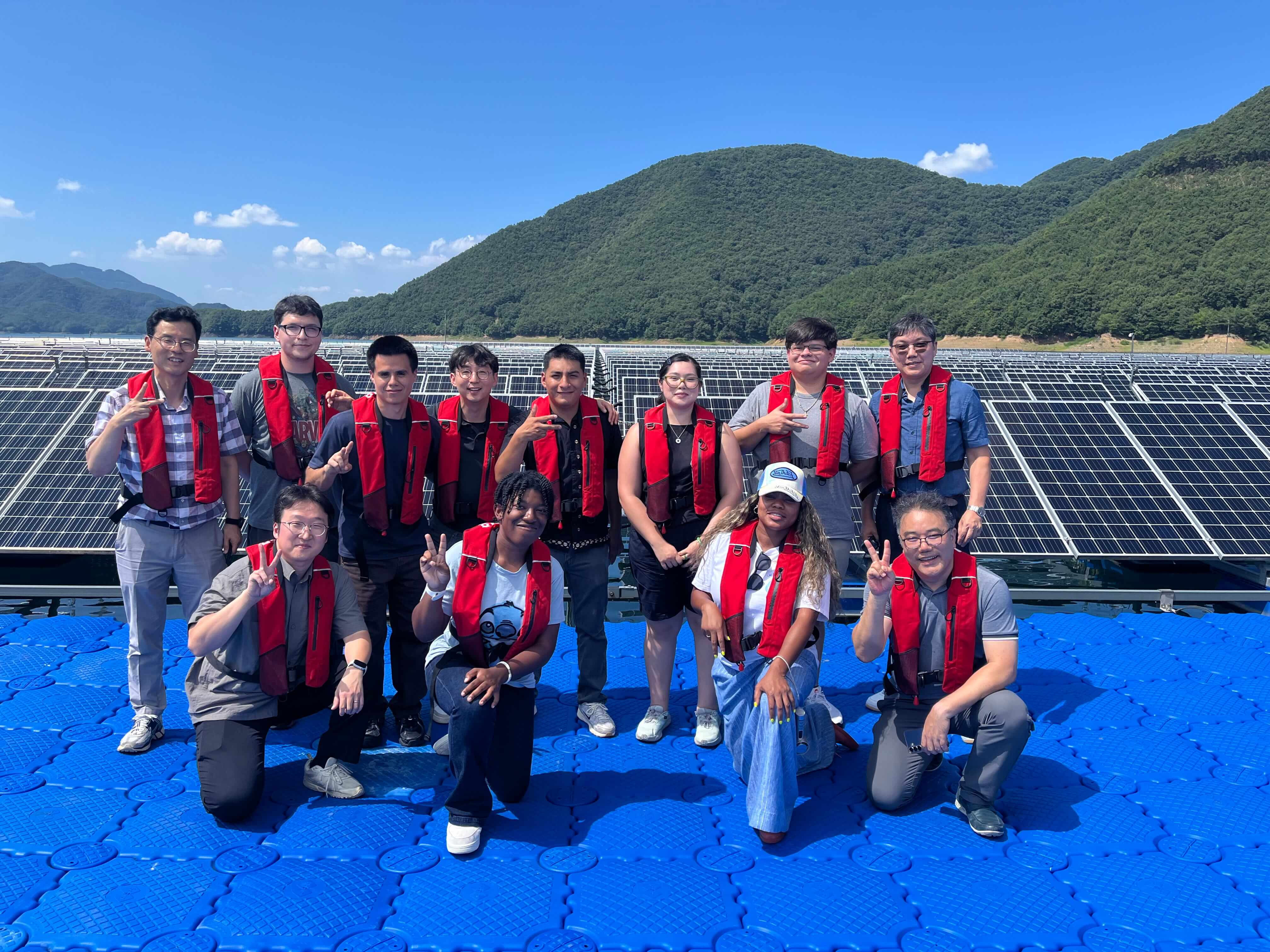 A group photo of CSUB students, lead professor Dr. Kim, and K-water personnel in front of a tidal power plant.